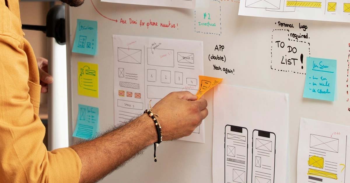Illustration of a designer creating intuitive UI and seamless UX across multiple devices